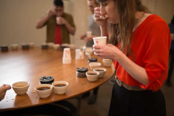 Eileen tasting coffee at coffee cupping