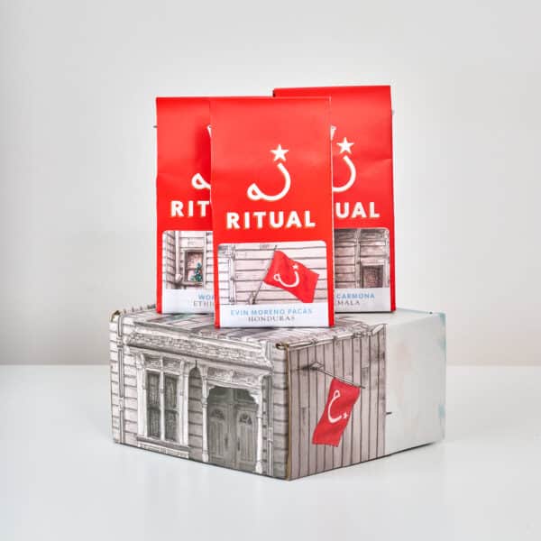 Three 4 oz bags of drip coffee on top of gift box