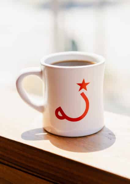 Coffee in a mug with the Ritual cup and star logo.