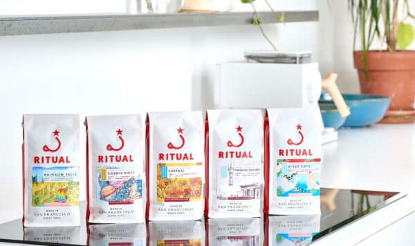 Five seasonal espresso bags lined up on the kitchen counter