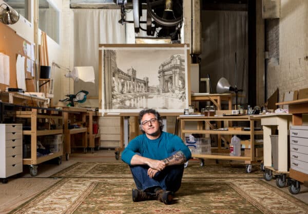 Paul Madonna sitting on the floor of his studio.
