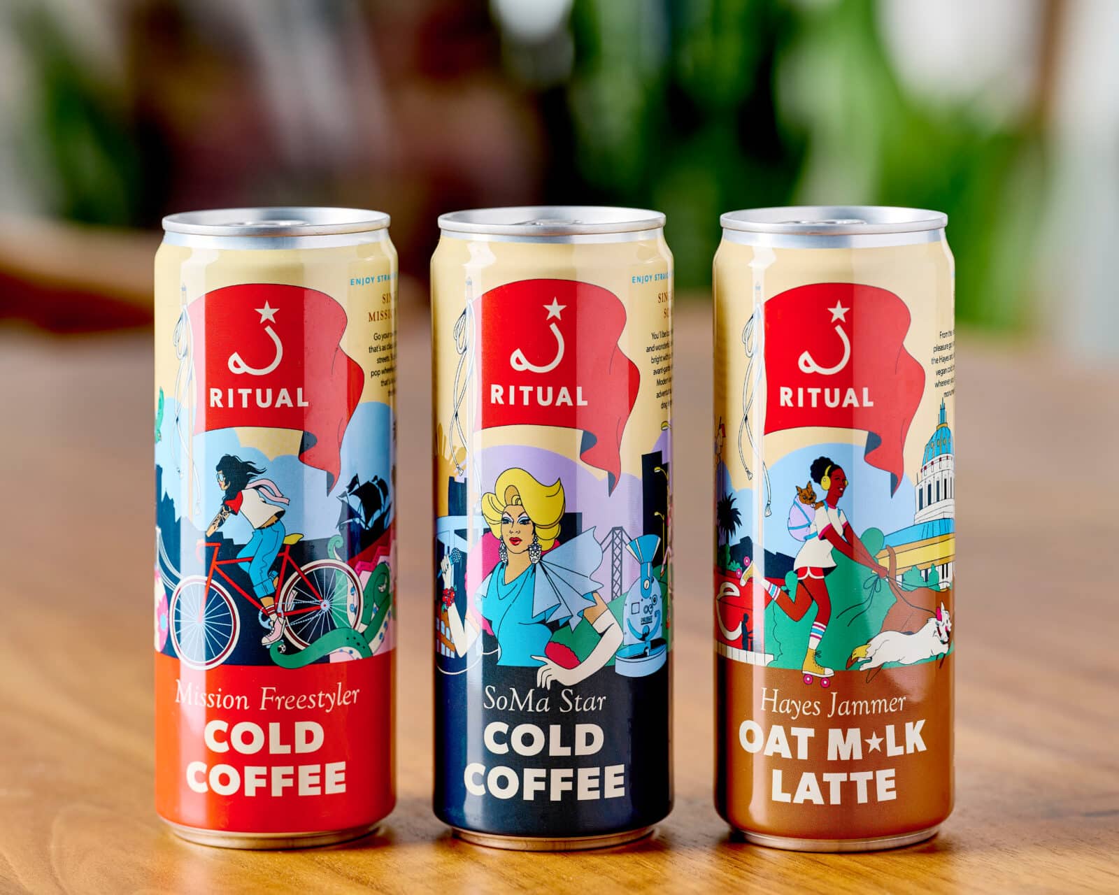 3 canned coffees on wooden table